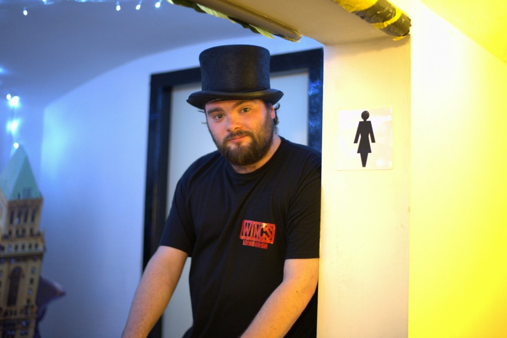 He's loitering by the ladies loo because that's where the Dr Who table is, right by the toilet.